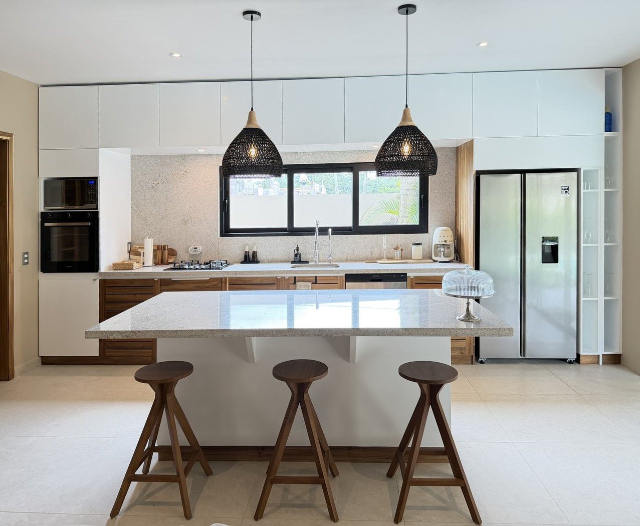 La cuisine et son îlot de granit sous les suspensions de rotin — Villas Origen